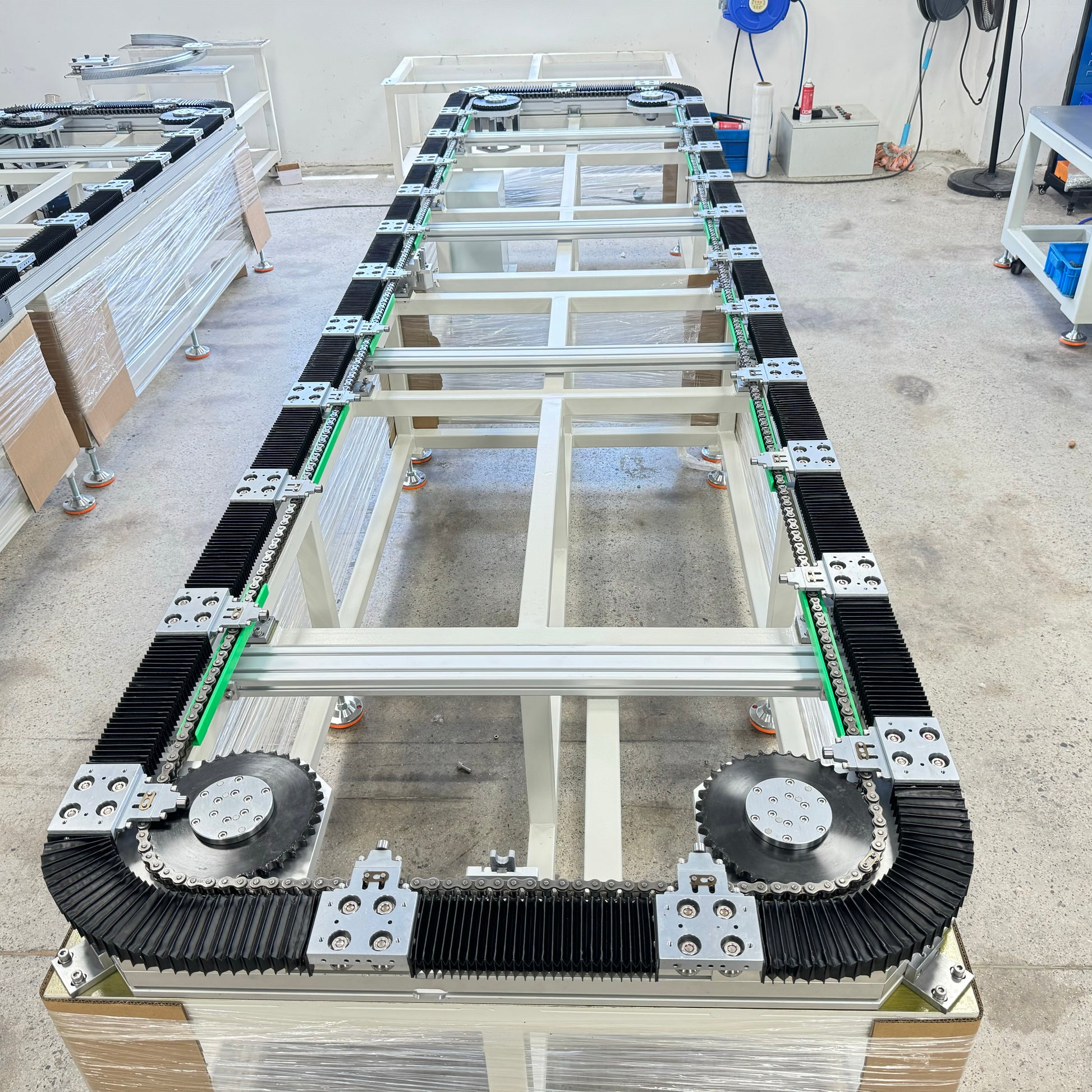 Global rendering of chain-type rectangular drive track system with accordion cover